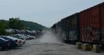 Discharge of air kicks up a little dust as NS E19 and CSX grain/ethanol combo rolls by